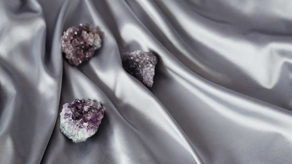 Amethyst crystals on silky blanket