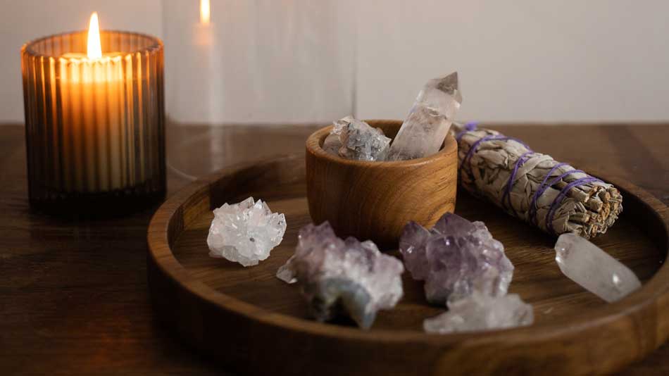 Smudging crystals with sage 